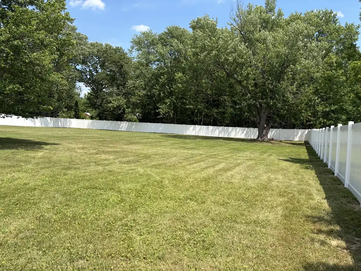 White vinyl fence enclosing a Northern Virginia yard, under Our Fencing Projects