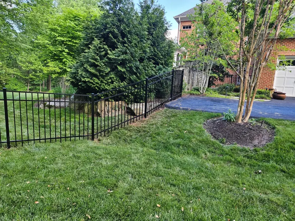 Four-foot black aluminum fence along a walkway, under Our Fencing Projects