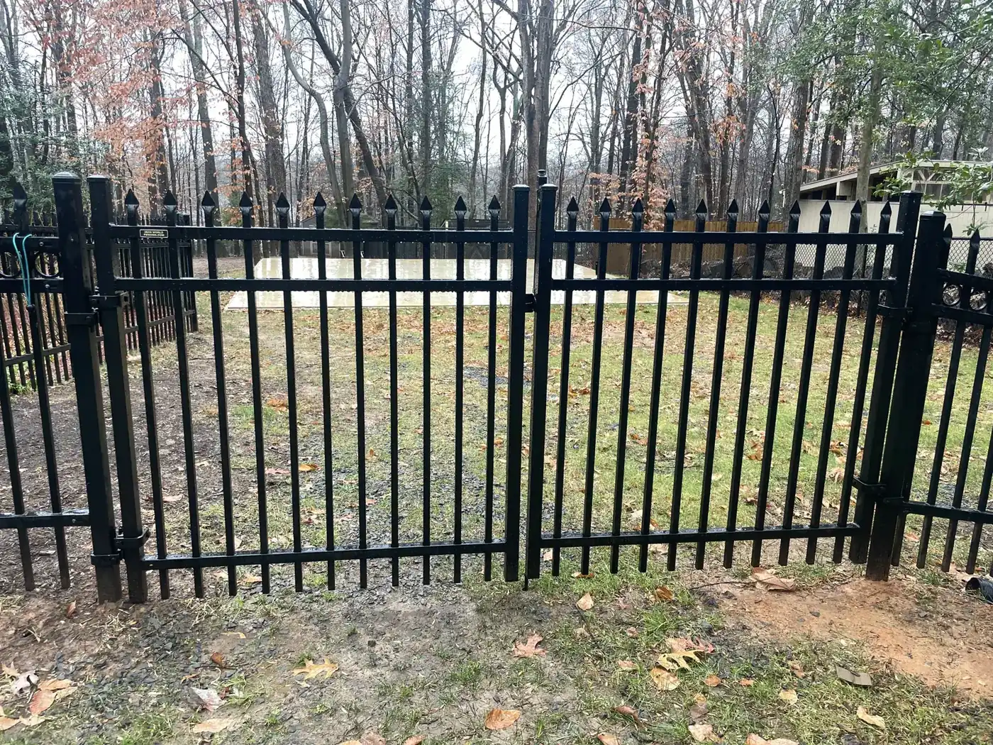 Black aluminum dual swing gate with finial tops, under Our Fencing Projects