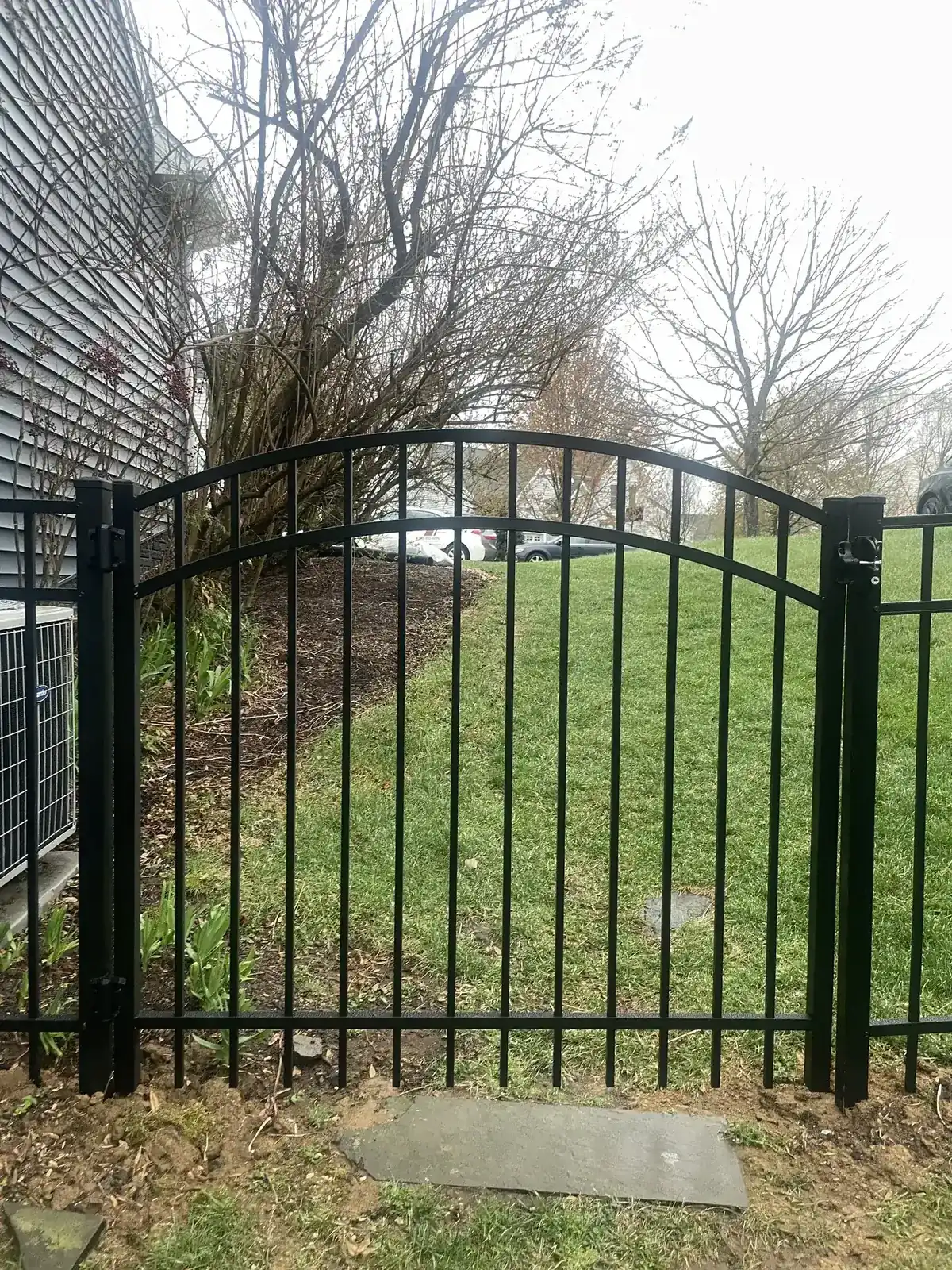 Black aluminum fence along a residential driveway, under Our Fencing Projects