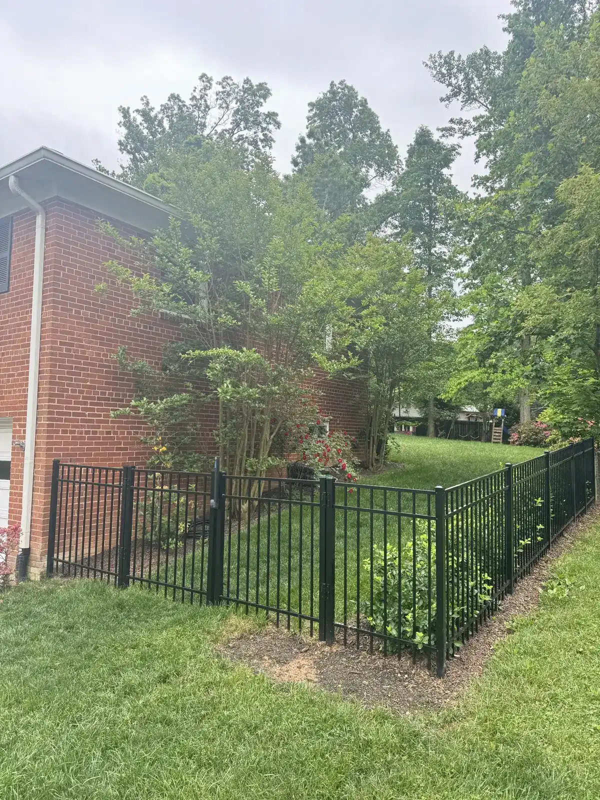 Black aluminum fence along a landscaped frontage, under Our Fencing Projects