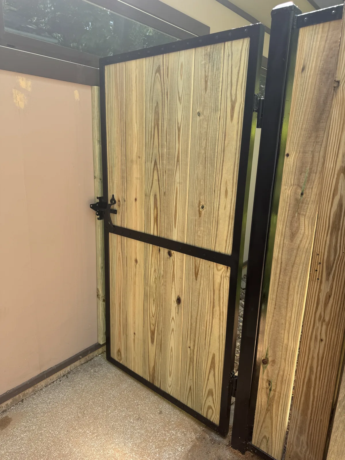 Black aluminum walk gate installed on a grass line, under Our Fencing Projects
