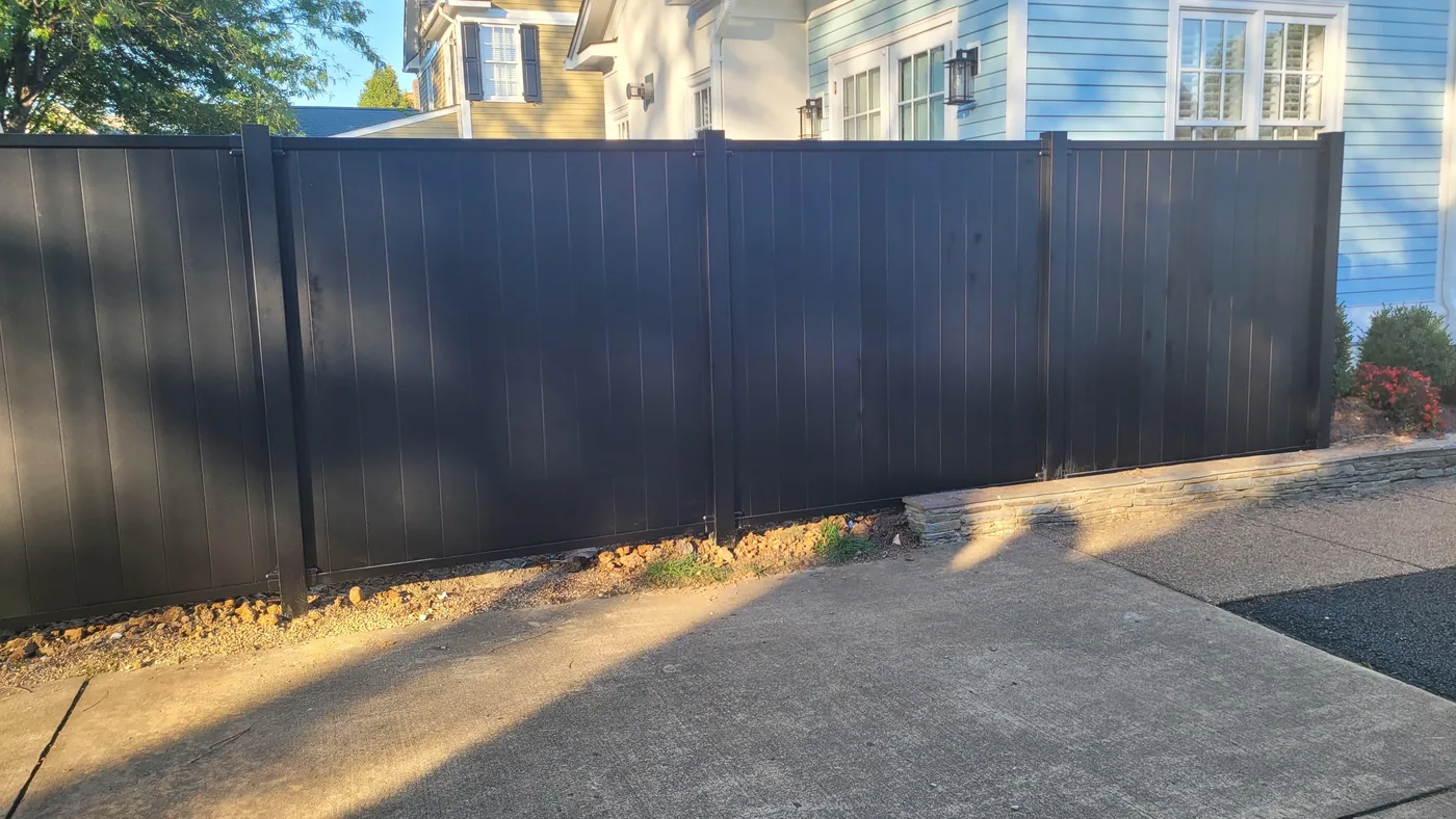 Black aluminum privacy fence panel line, under Our Fencing Projects