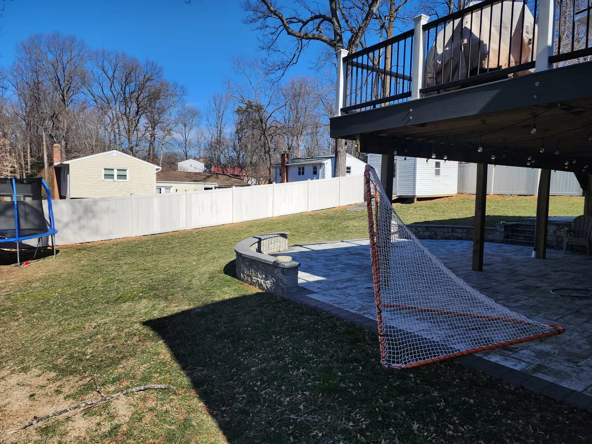 Aspen vinyl privacy fence line beside a lawn, under Our Fencing Projects
