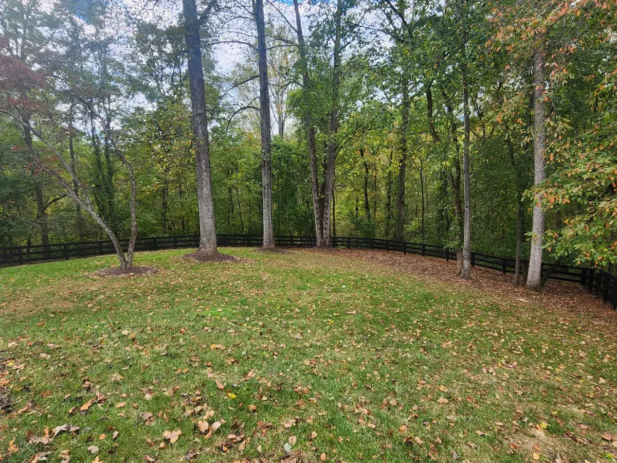 Black ranch rail fence at a pasture corner, under Our Fencing Projects