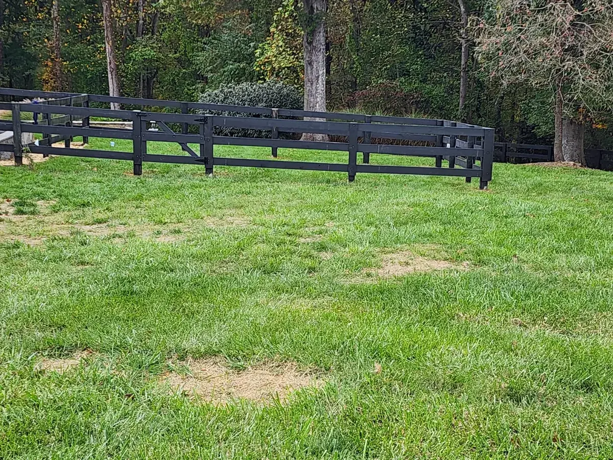 Black four-foot ranch rail fence on a rural property, under Our Fencing Projects