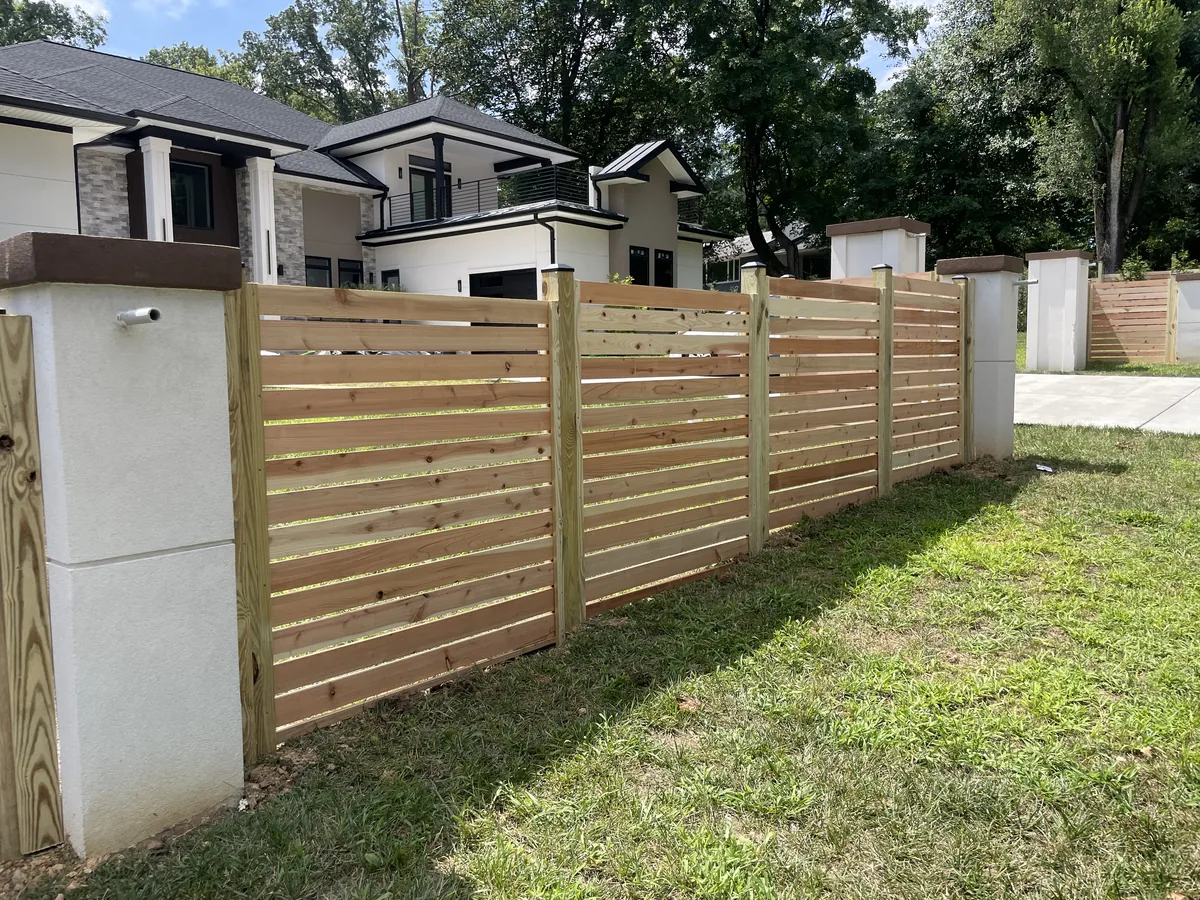 Spaced cedar fence line with 1x4 boards, under Our Fencing Projects