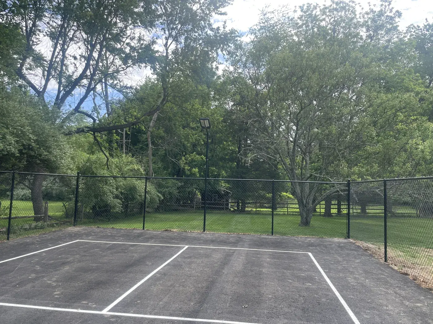 Chain link enclosure around a sport court, under Our Fencing Projects