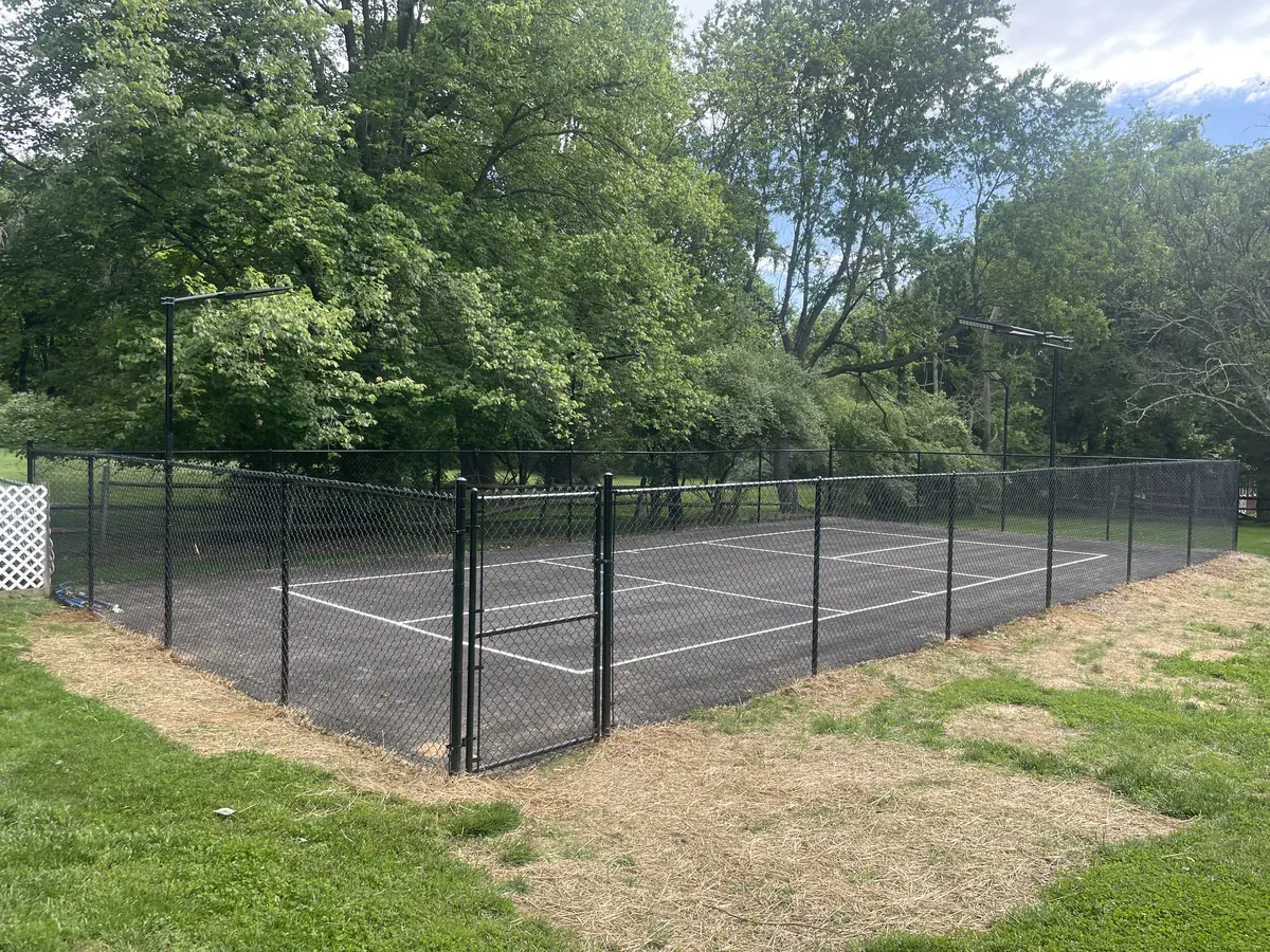 Black chain link fencing around a sport court, under Our Fencing Projects