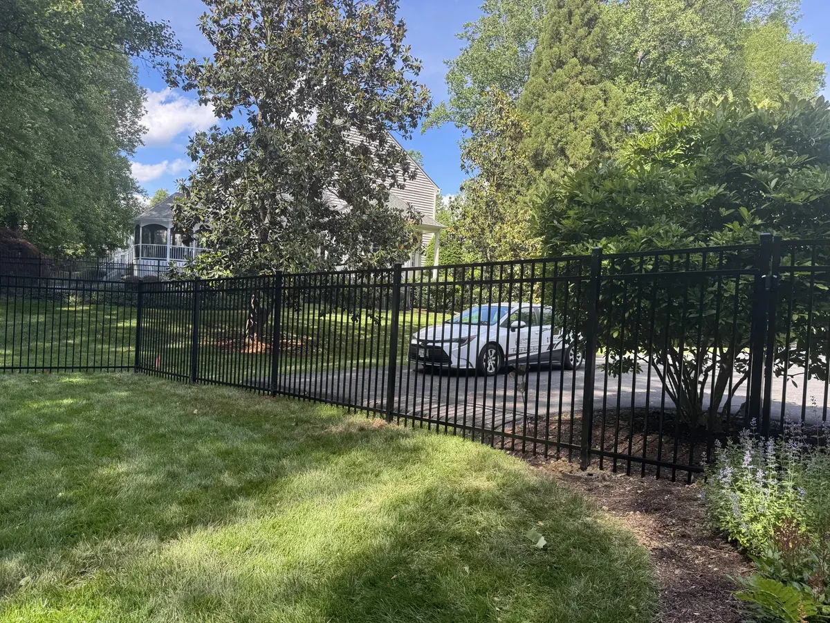 Six-foot black aluminum fence on a commercial property, under Our Fencing Projects
