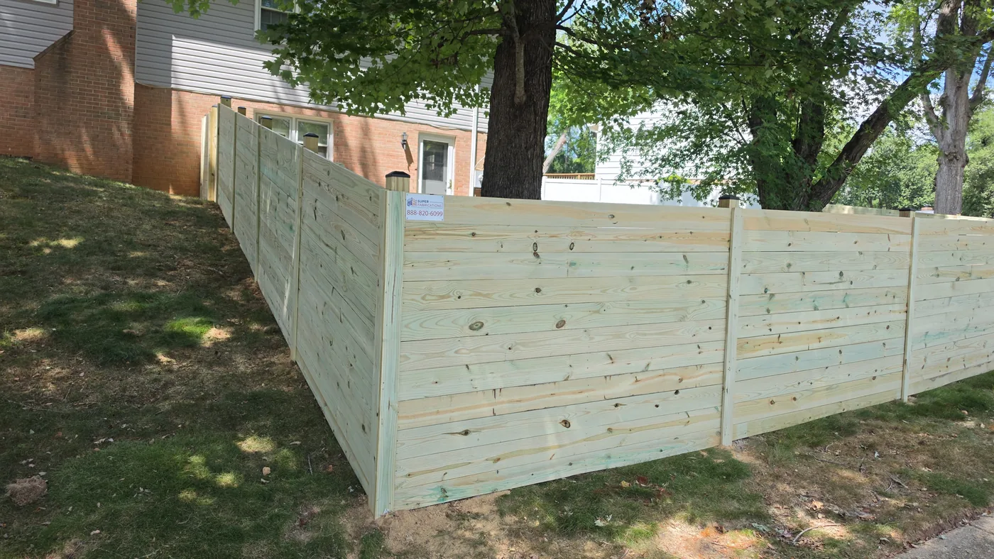 Wood fence panels stepping down with the yard grade, under Our Fencing Projects