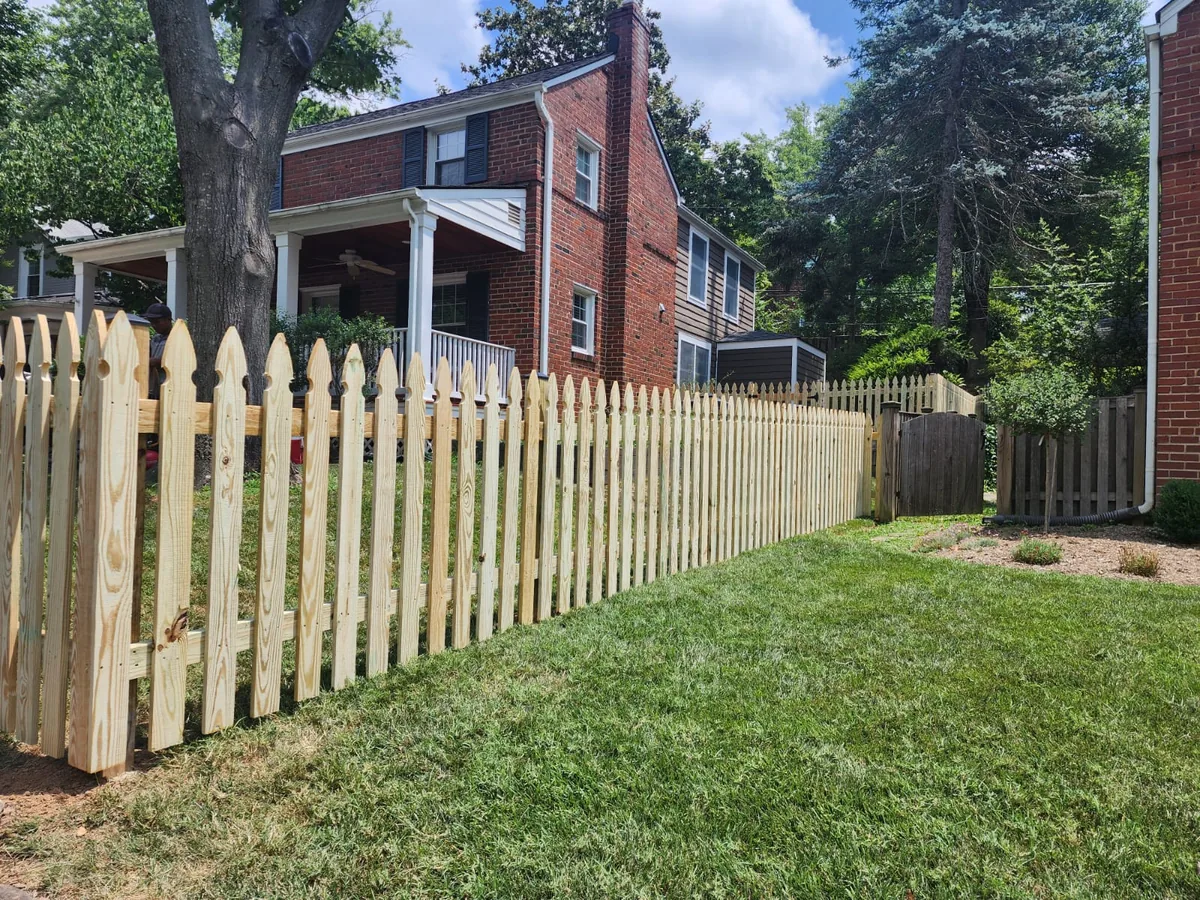 Wood gothic-point picket fence along a lawn, under Our Fencing Projects