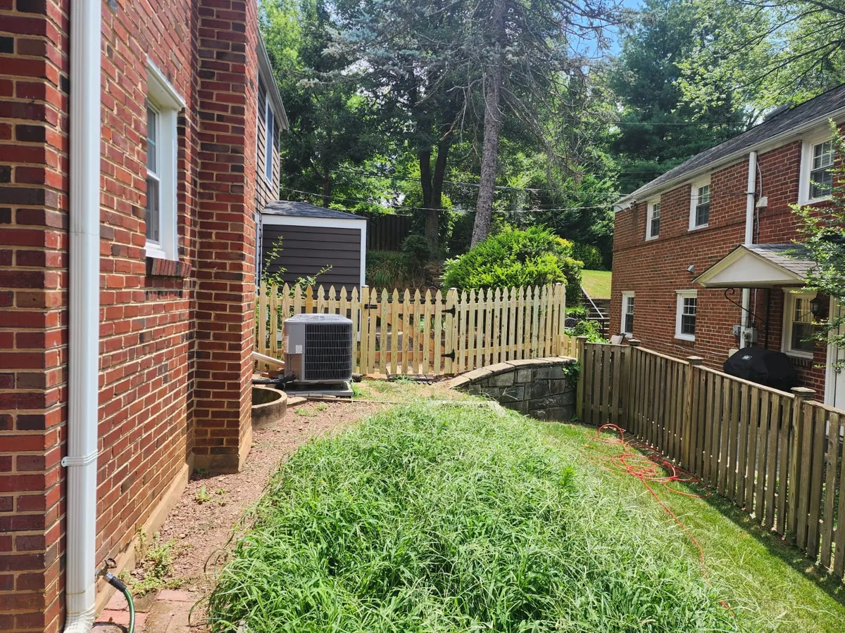 Gothic-point picket fence across a front yard, under Our Fencing Projects