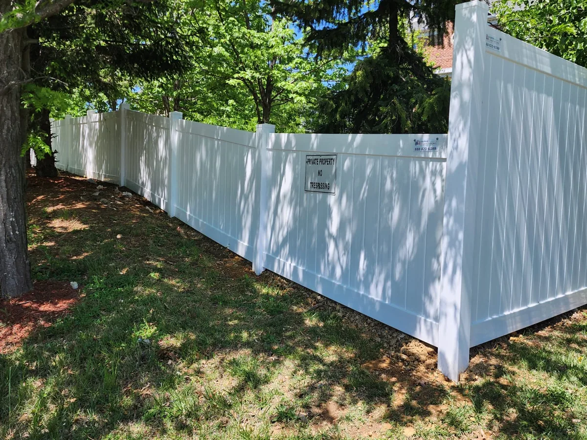 White vinyl privacy fence along an HOA common area, under Our Fencing Projects