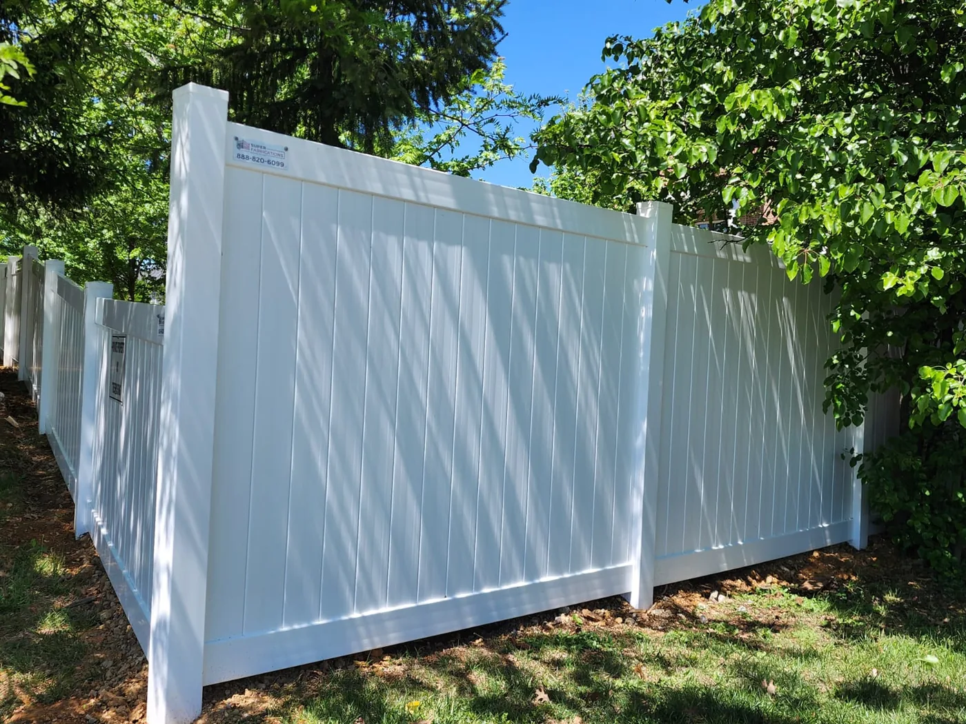 White vinyl privacy fence installed for a Northern Virginia HOA beside townhomes, under Our Fencing Projects