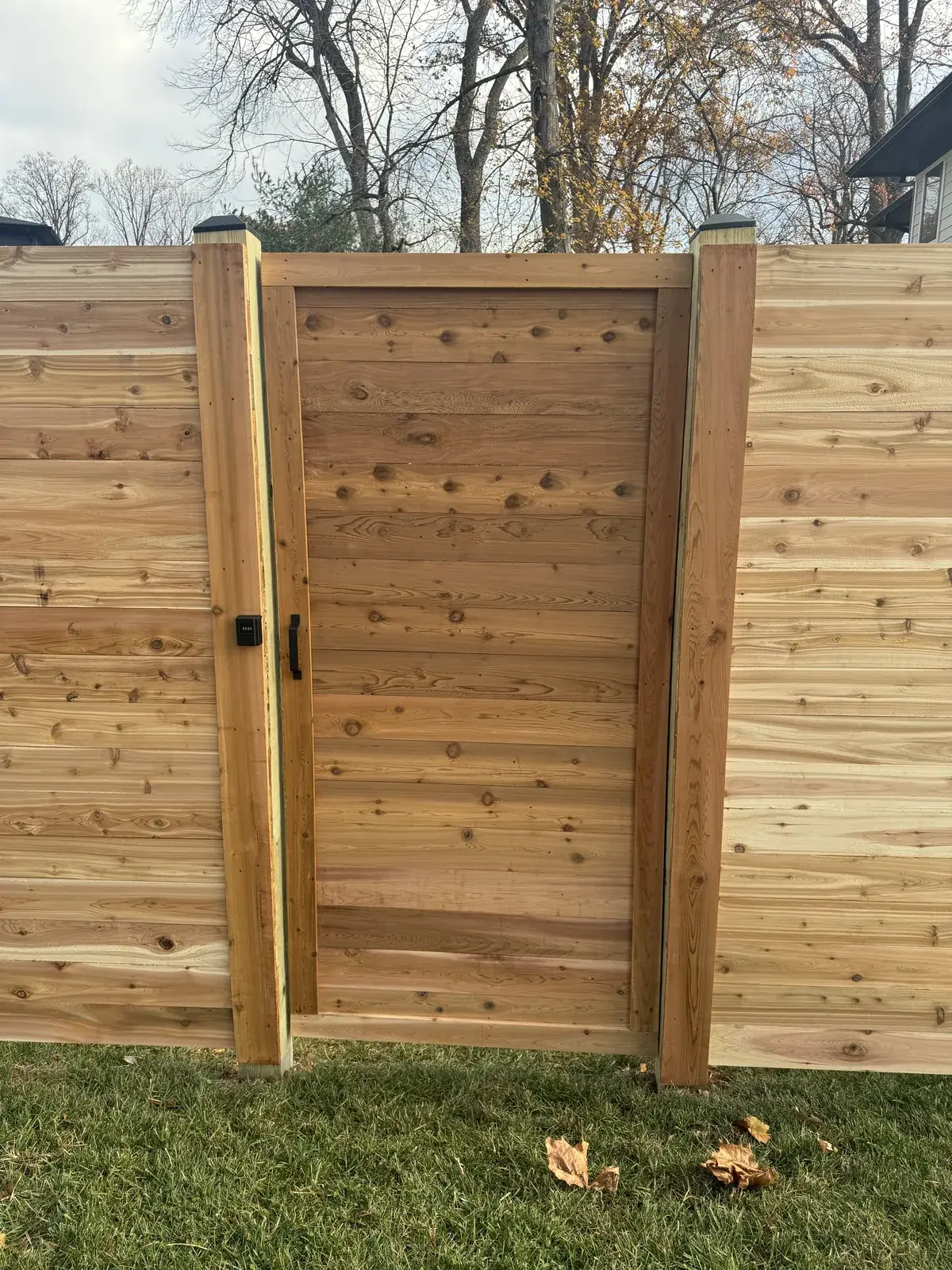 Horizontal cedar fence with a matching walk gate, under Our Fencing Projects