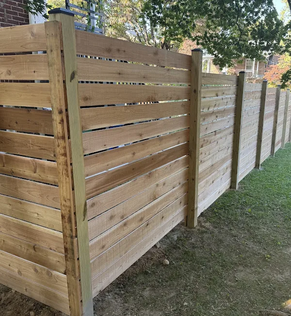Horizontal wood privacy fence wrapping a backyard corner, under Our Fencing Projects