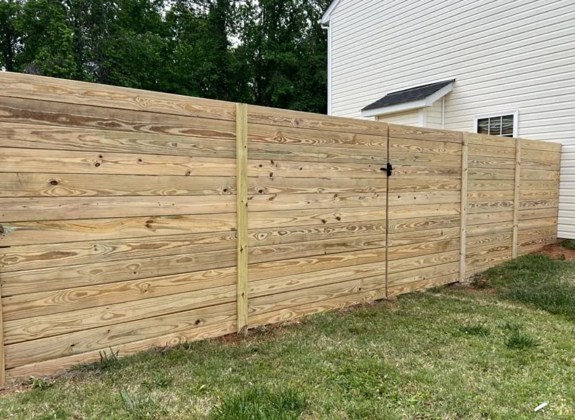 Horizontal wood privacy fence with a matching walk gate, under Our Fencing Projects