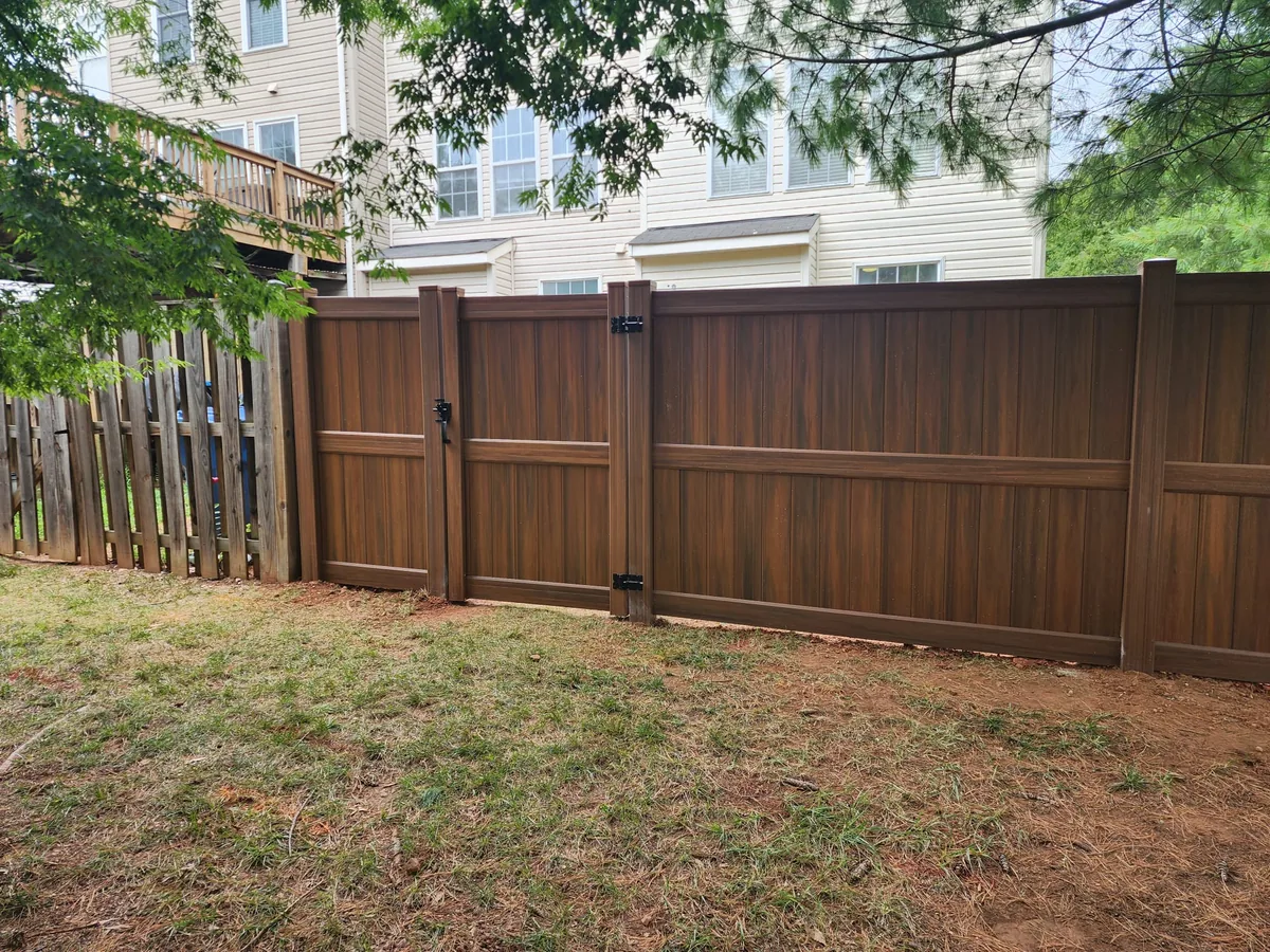 Mocha vinyl privacy fence line in a community, under Our Fencing Projects