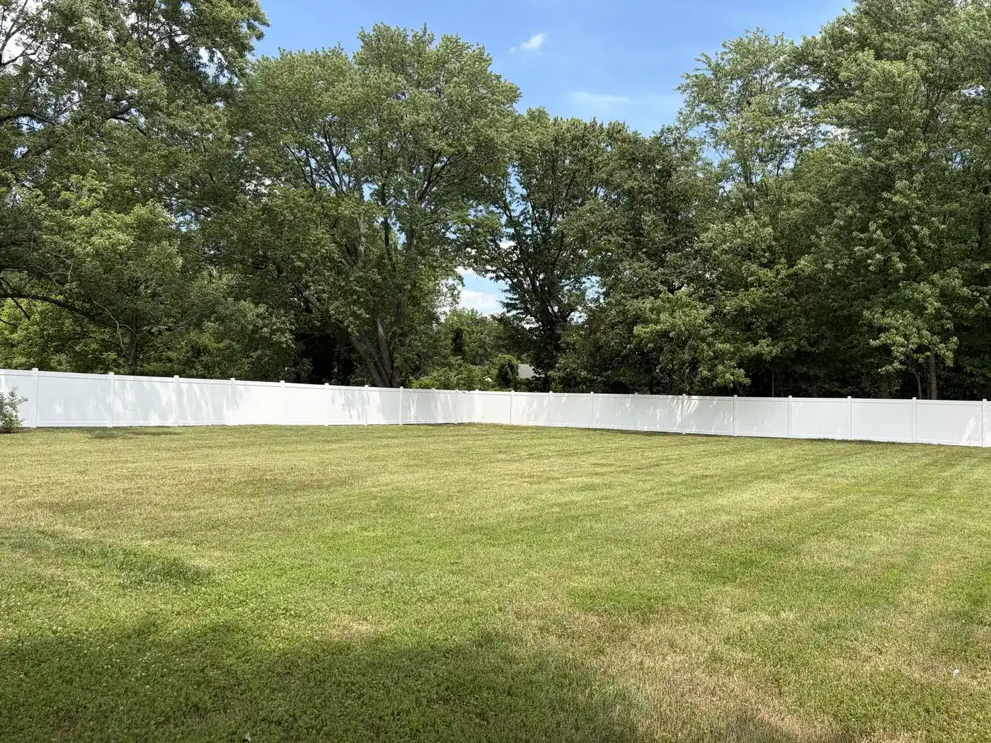 White Nexus-style vinyl privacy fence with wide rails in a Northern Virginia yard, under Our Fencing Projects