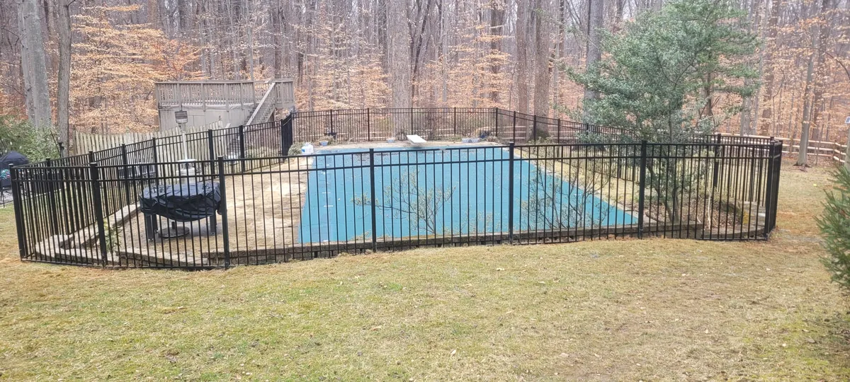 Black aluminum pool fence with a self-closing gate, under Our Fencing Projects
