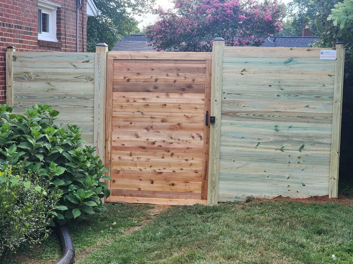 Pressure-treated privacy fence enclosing a backyard, under Our Fencing Projects