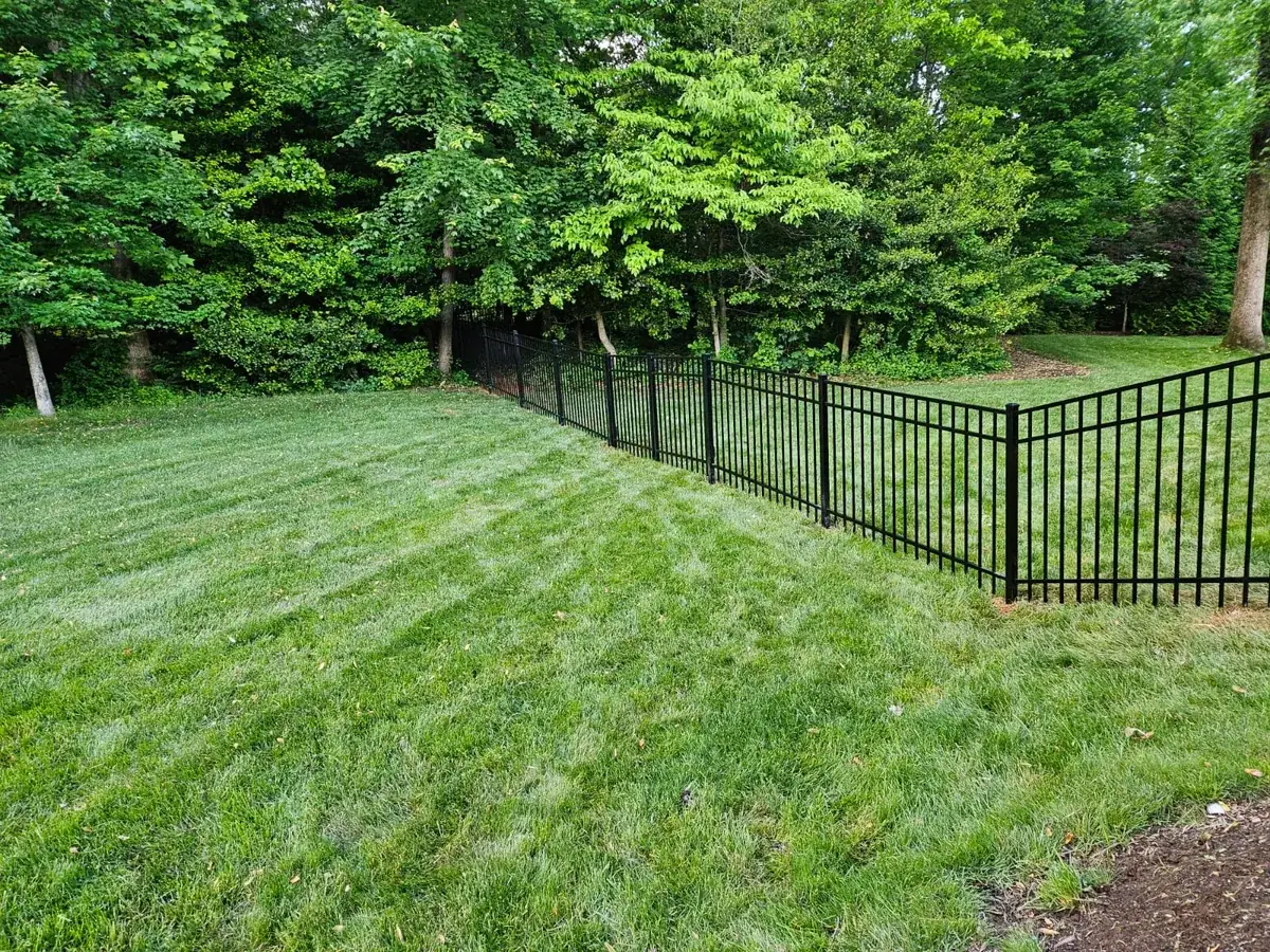 Four-foot black aluminum fence along a front walk, under Our Fencing Projects