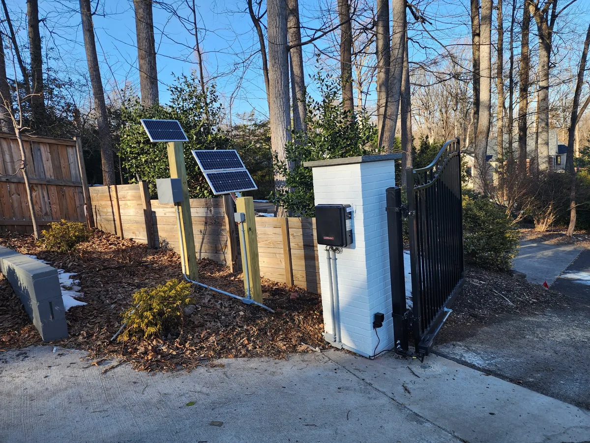 Solar-powered gate open across a drive, under Our Fencing Projects