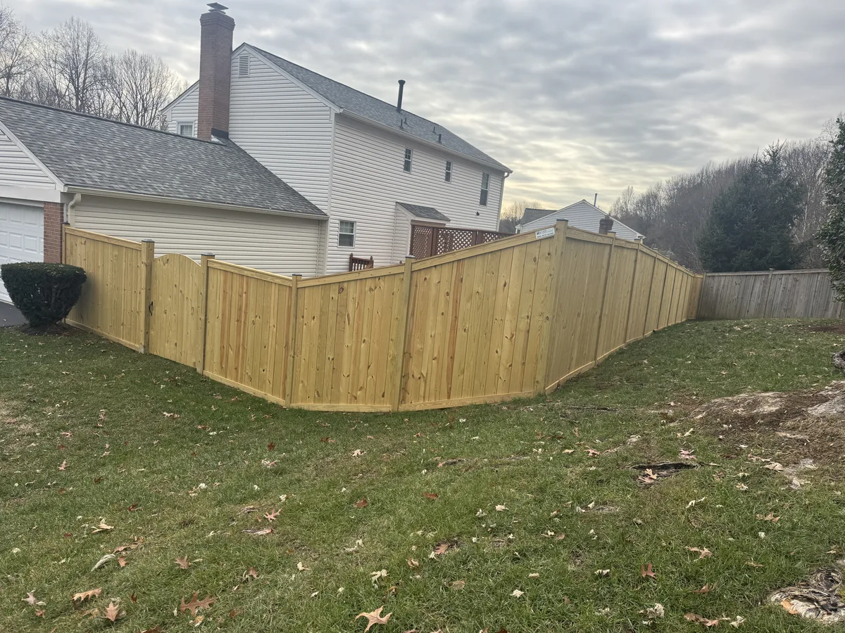 Wood stockade fence with cap and trim detail, under Our Fencing Projects