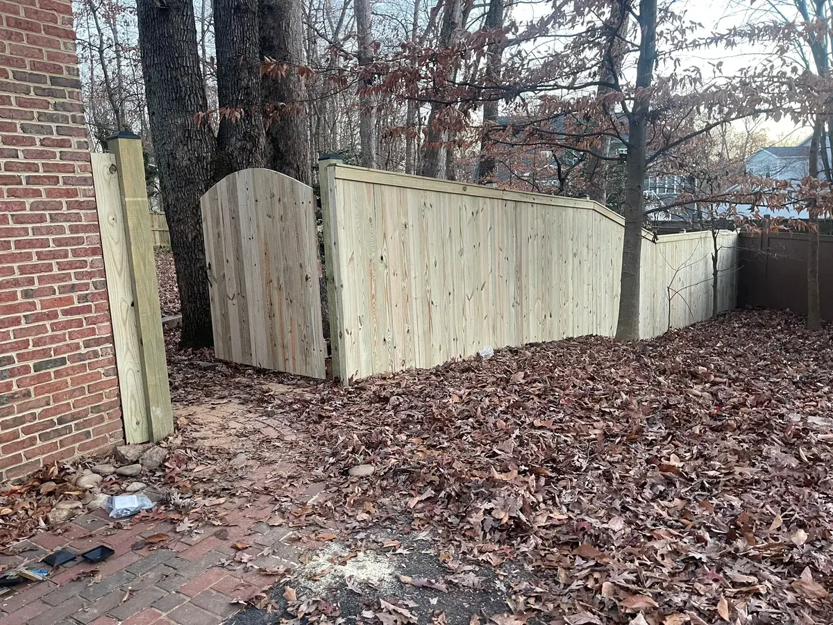 Wood stockade fence around a backyard, under Our Fencing Projects