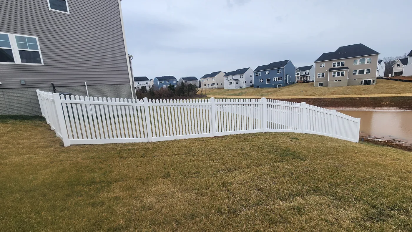 White vinyl straight-top picket fence along a frontage, under Our Fencing Projects