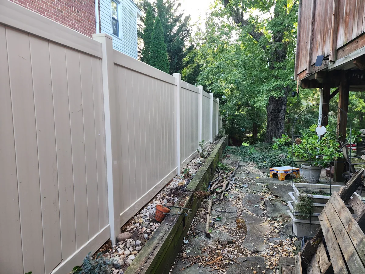 Tan vinyl privacy fence along a narrow side yard, under Our Fencing Projects