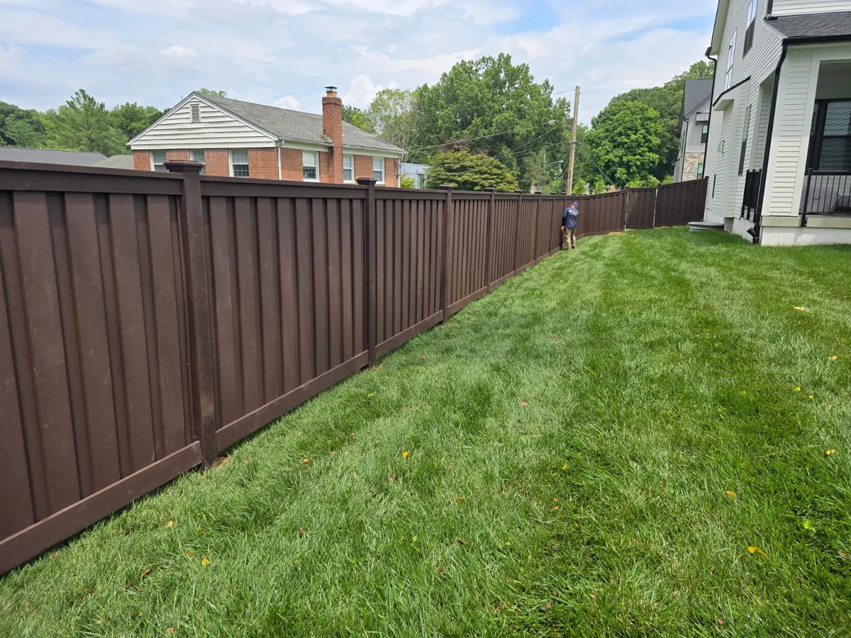 Brown composite privacy fence running a backyard property line, under Our Fencing Projects