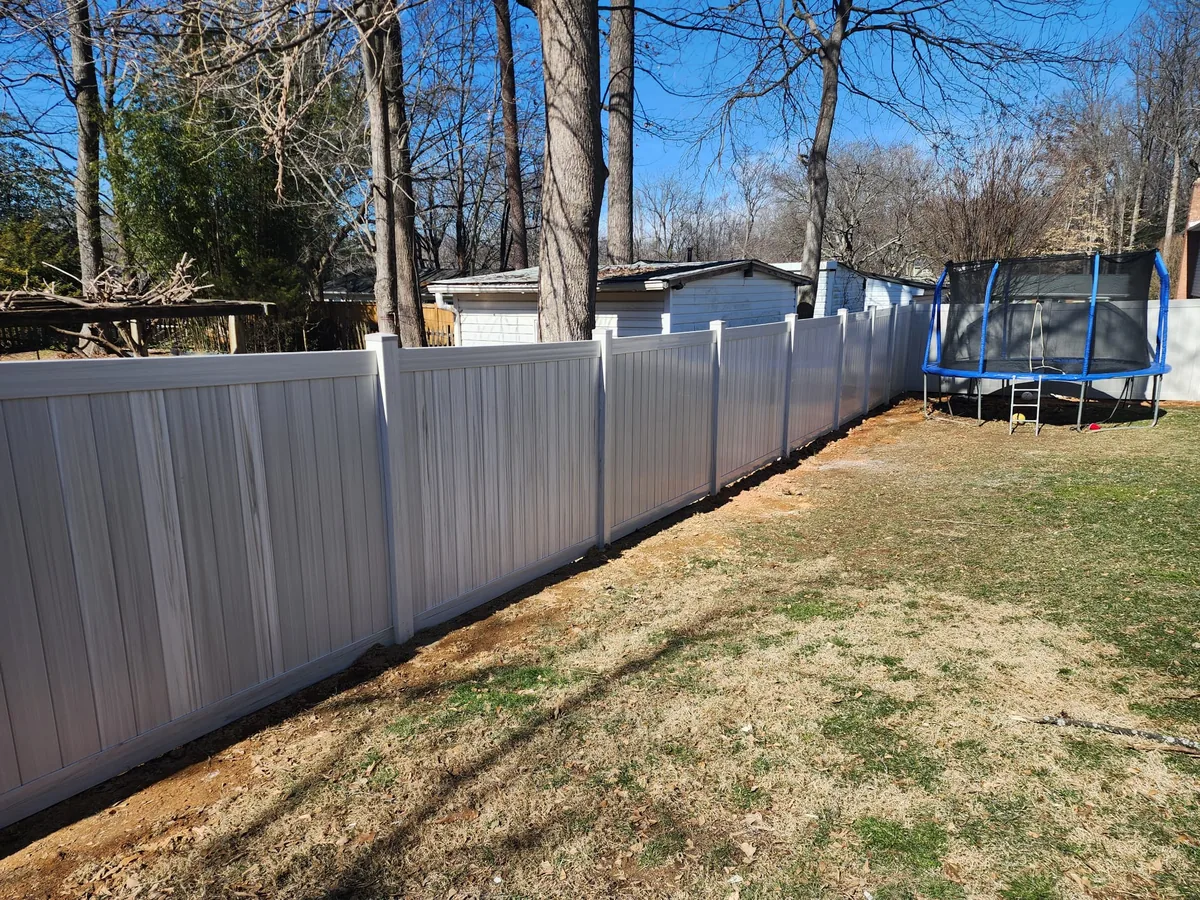 Aspen-style vinyl privacy fence line in a backyard, under Our Fencing Projects