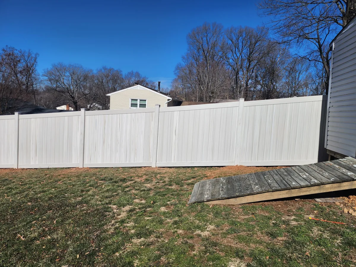 Weathered gray Aspen-style vinyl privacy fence, under Our Fencing Projects
