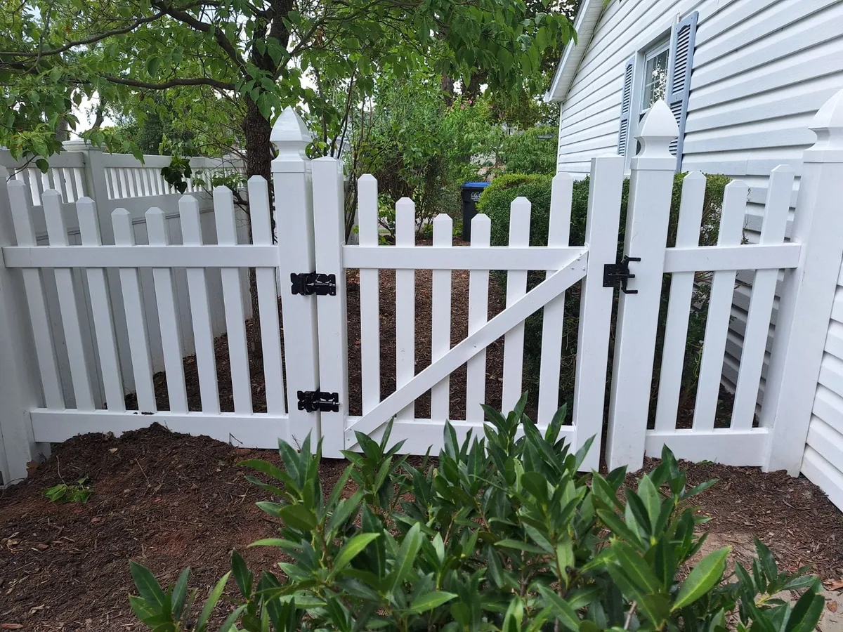 White vinyl dog-ear picket fence line, under Our Fencing Projects