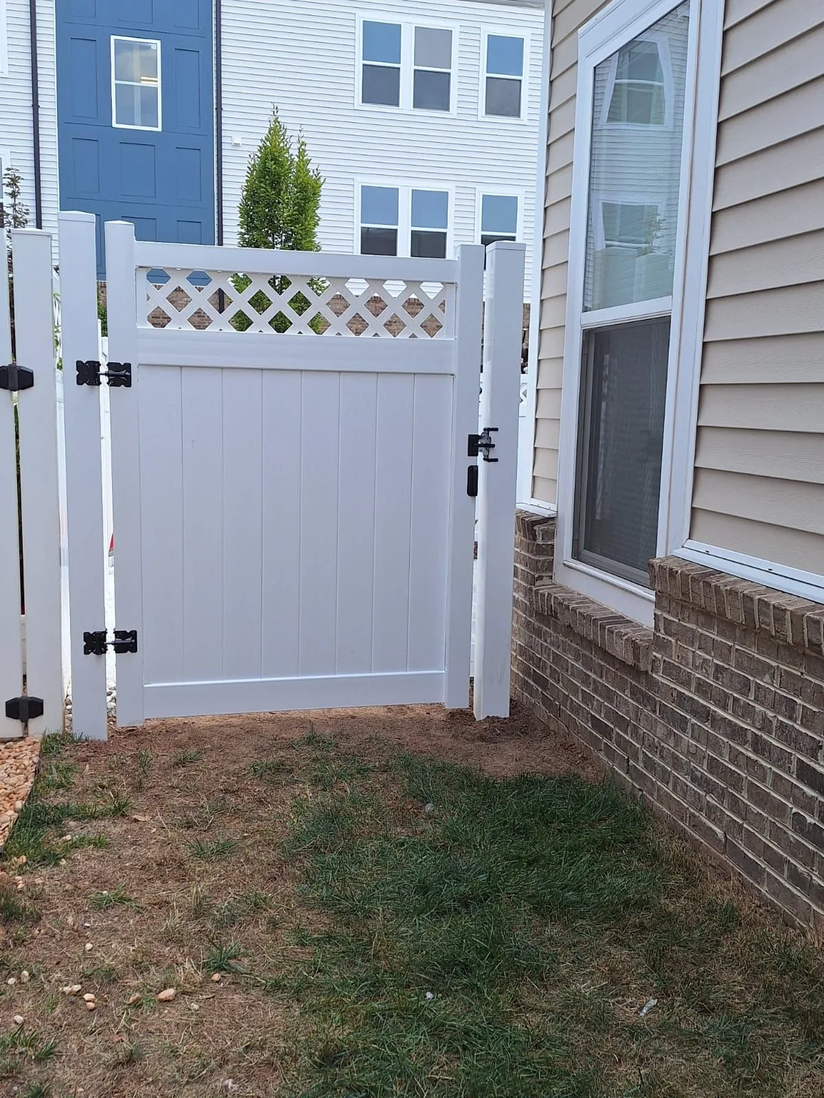 White vinyl privacy fence with a lattice top, under Our Fencing Projects