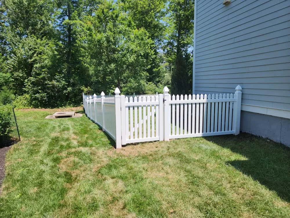 White vinyl spaced picket fence along a walkway, under Our Fencing Projects