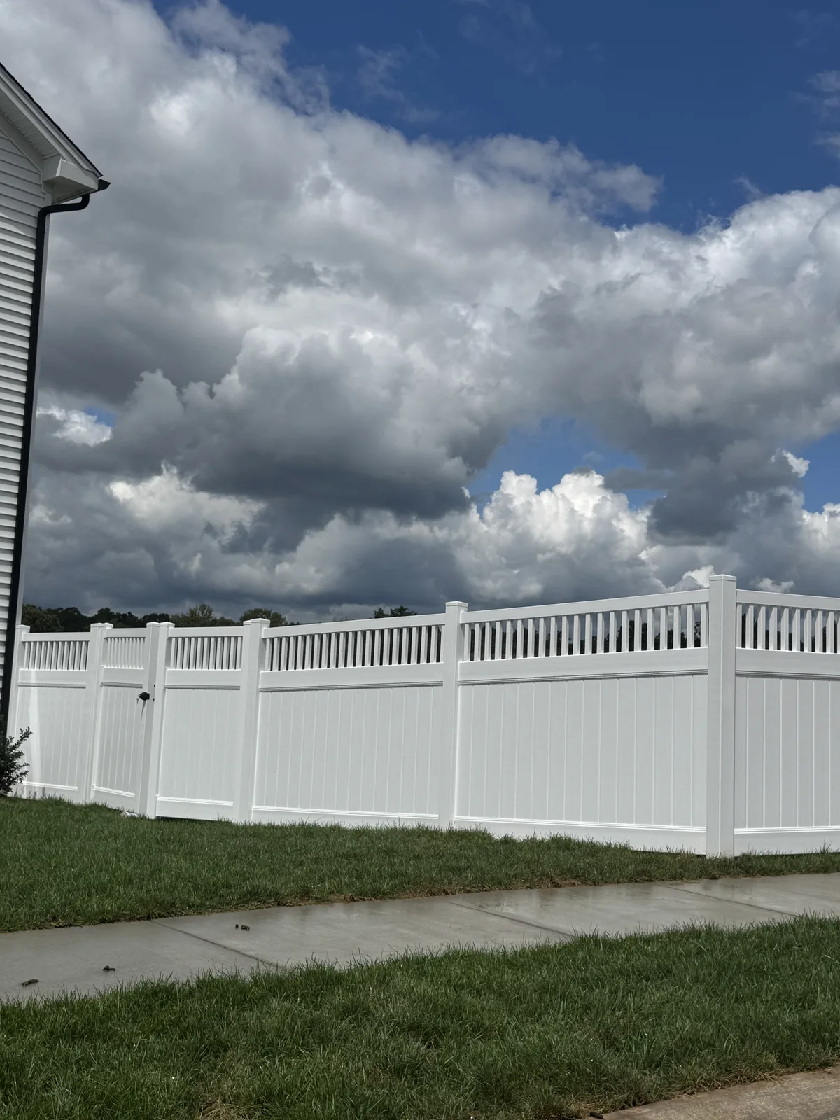 White vinyl fence with a spindle top accent, under Our Fencing Projects