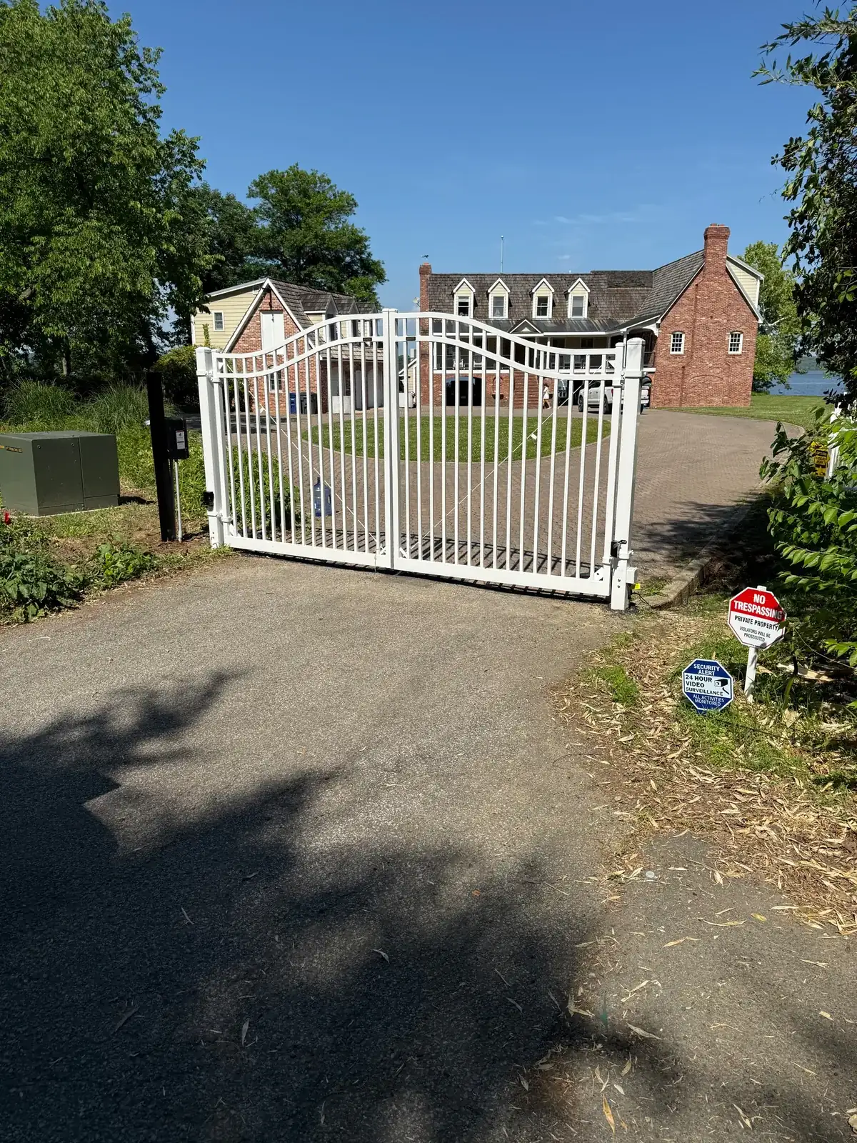White arched aluminum driveway gate, under Our Fencing Projects