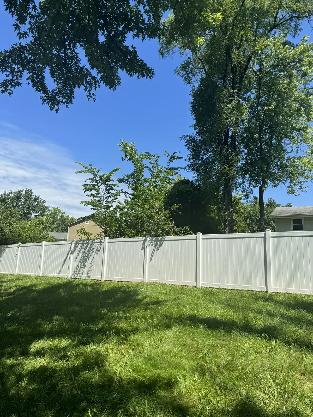 White vinyl privacy fence with a clean top line, under Our Fencing Projects