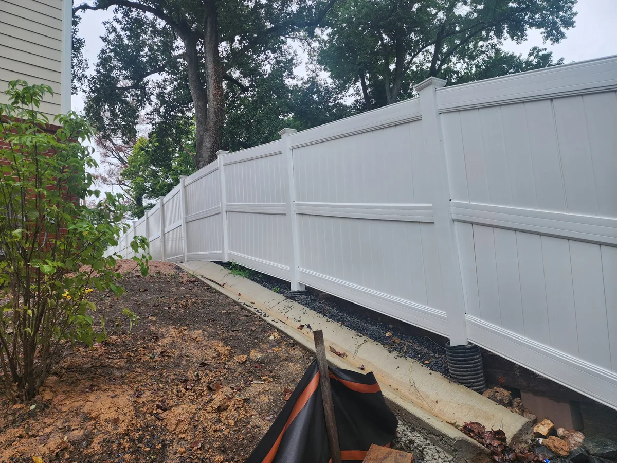 White vinyl three-rail fence on an open lawn, under Our Fencing Projects