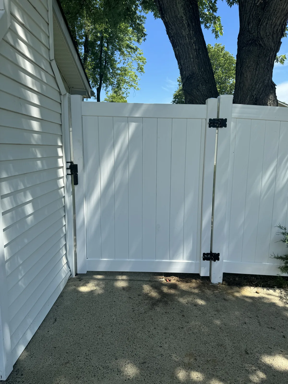 White vinyl privacy fence along a side yard, under Our Fencing Projects