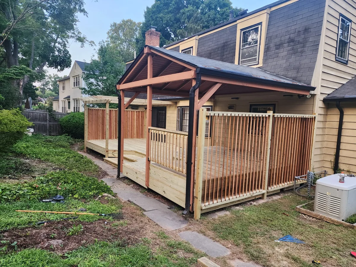 Wood fence above a backyard deck area, under Our Fencing Projects