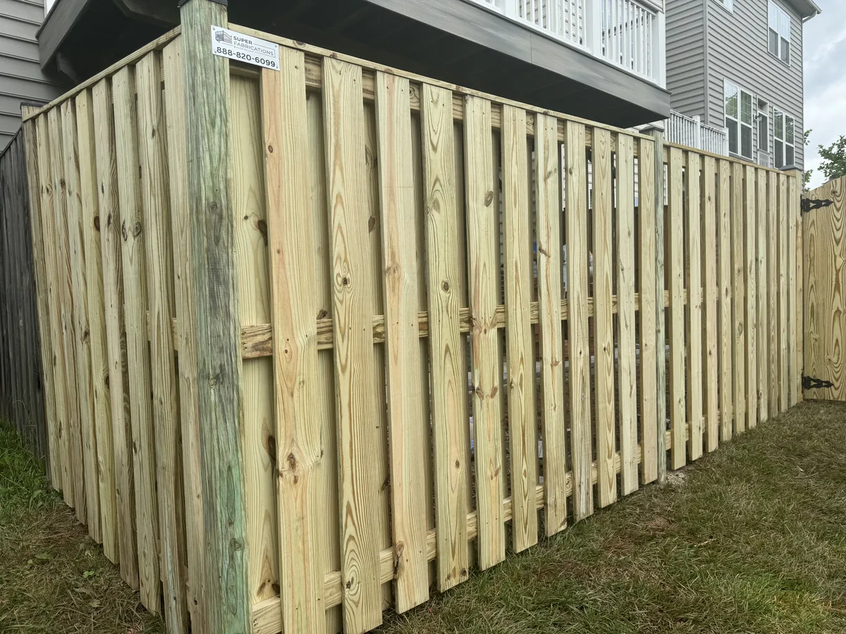 Wood shadowbox fence with a matching walk gate, under Our Fencing Projects