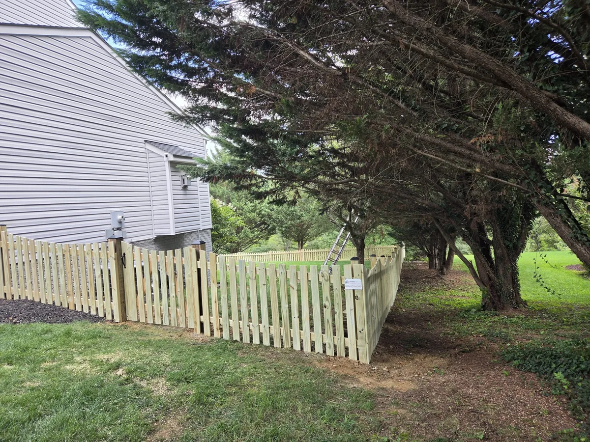 Scalloped wood spaced picket fence around a backyard patio, under Our Fencing Projects
