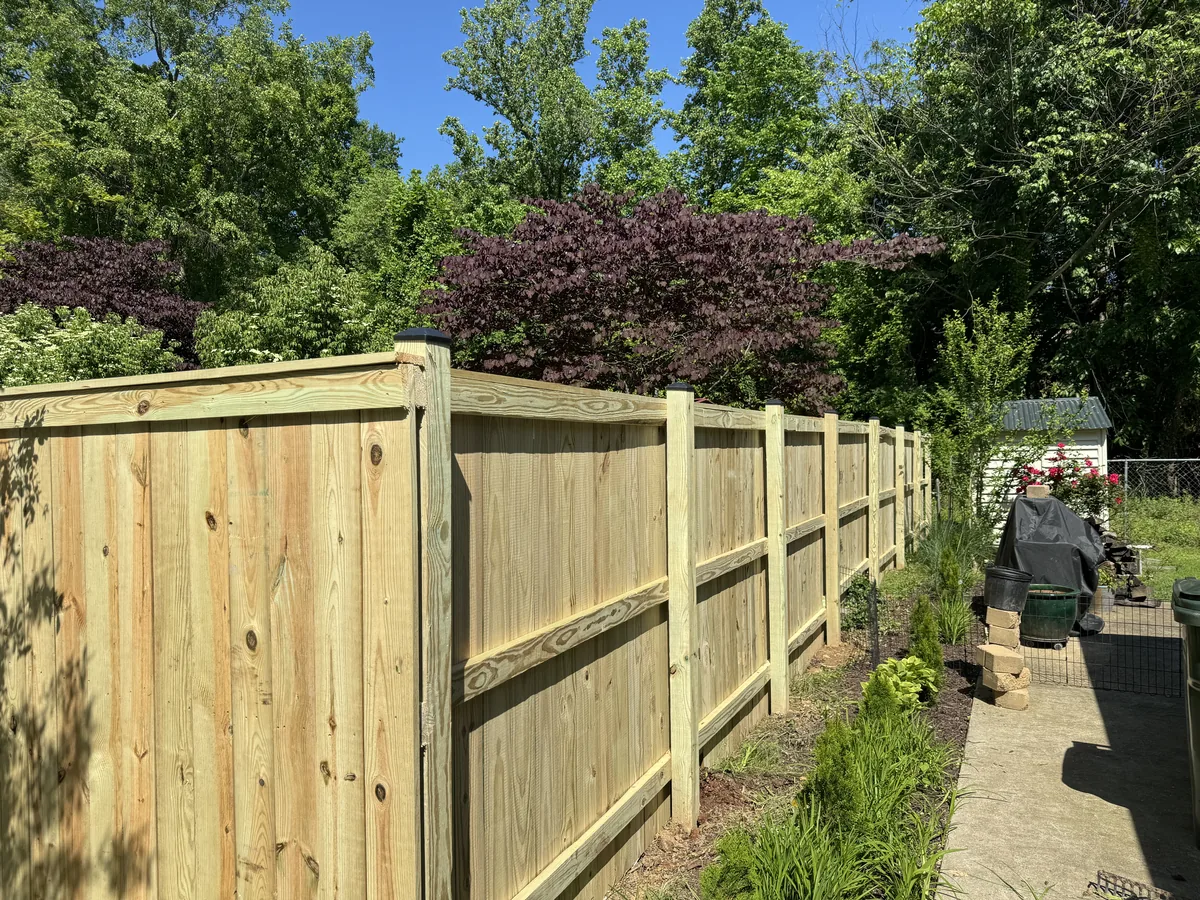 Wood stockade privacy fence along a property line, under Our Fencing Projects