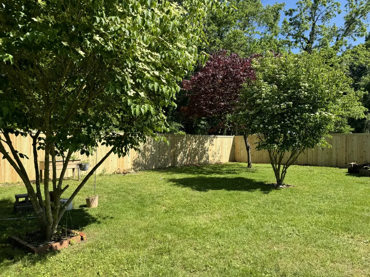 Wood stockade privacy fence enclosing a backyard, under Our Fencing Projects