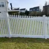 a white vinyl fence in front of a house
